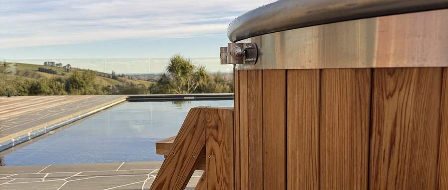 Tubby hot tub beside a pool in the Port Hills, overlooking the Canterbury Plains