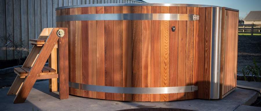 Tubby hot tub beside an outdoor fire bowl at dusk in West Melton